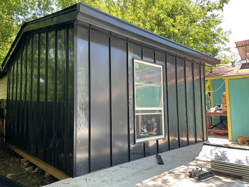 Black standing seam metal wall panels for Roof Inspection in Liberal